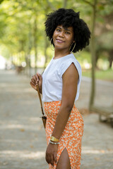 tall and beautiful girl walks in the park. female portrait
