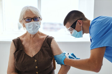 Obraz premium elderly woman patient and doctor vaccine passport immunity protection