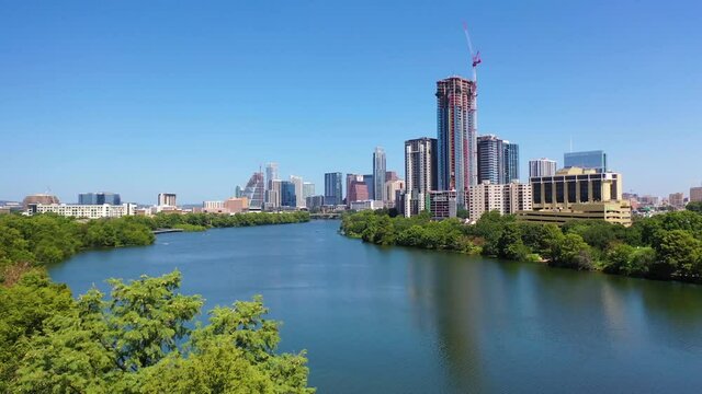 Beautiful aerial over the Colorado River in downtown Austin, Texas with skyline background.