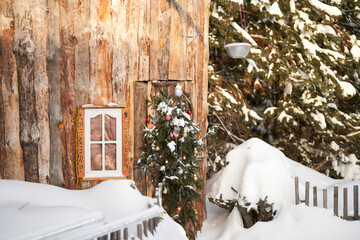 A journey into a fairy tale. A wooden fairy-tale house with a Christmas wreath on the door in the...