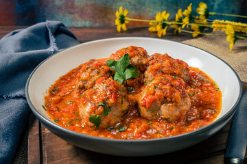 Meat balls or meatloaf with tomato sauce in a round dish. High view