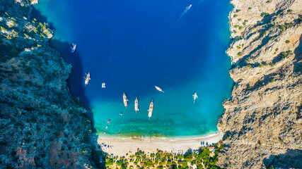 Butterfly Valley (Turkish: Kelebekler Vadisi) in Oludeniz. Beautiful beach aerial view with drone. Fethiye, Mugla, Turkey..