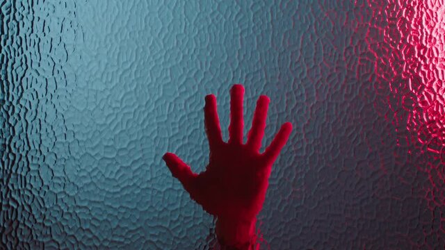 hand sliding down window dramatic death with red emergency lights flashing murder concept 