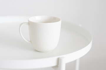 Fototapeta na wymiar white mug on white table 