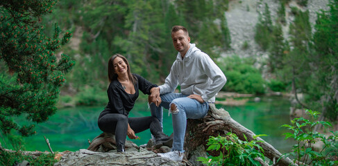 Naklejka na ściany i meble Couple posing in the forest in Alps 
