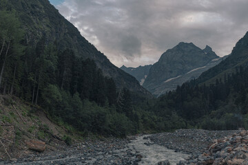 Landscape of high mountains, river and forest in Dombai