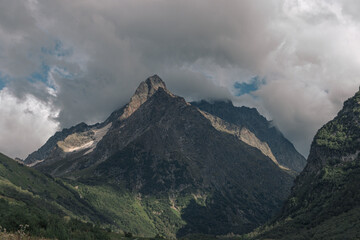 Landscape of high mountains, river and forest in Dombai