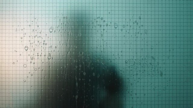 person cleaning window with water and soap janitor silhouette