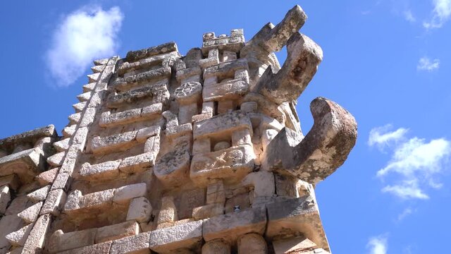 2021 - Many representations of the face of Chaac, Mayan god of rain, adorn the exterior of a temple in Mexico.