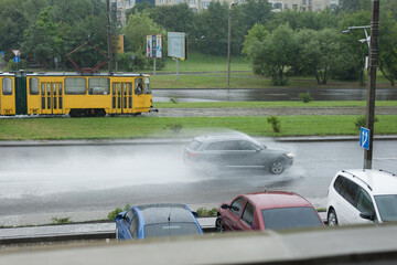 Fototapeta na wymiar Lviv, Ukraine - 07.31.2021: vehicles overcomes water obstacles on the streets caused by heavy rains