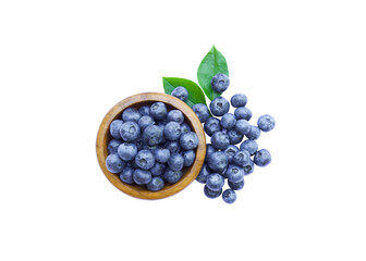 Bowl of fresh organic blueberries with leaves isolated. White background.