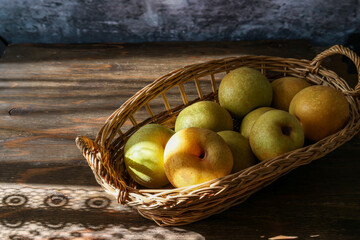 籠に盛った木材背景の和梨