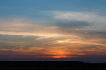 Fototapeta na wymiar Sunset inMoscow oblast, Russia. Blue clouds. Orange sun strip.