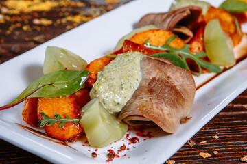 Boiled tongue with baked potato slices