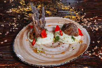 Legs of fried quail with mashed potatoes on a plate