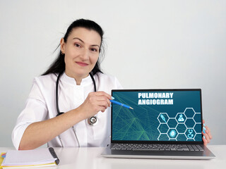  PULMONARY ANGIOGRAM inscription on the screen. Close up physician hands holding pen.