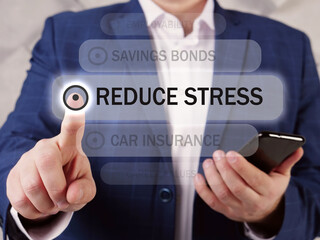  REDUCE STRESS phrase on the screen. Merchant use cell technologies at office. Stress reduction refers to various strategies that counteract this response and produce a sense of relaxation