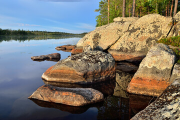 Karelian landscape - rocks, pine trees and water. Lake Pongoma, Northern Karelia, Russia