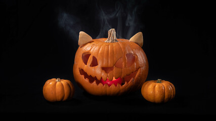 Illuminated jack o lantern halloween pumpkins, on black background	