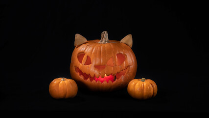 Illuminated jack o lantern halloween pumpkins, on black background	