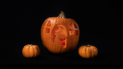 Illuminated jack o lantern halloween pumpkins, on black background	