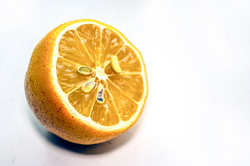 Yellow lemon with pits on the windowsill