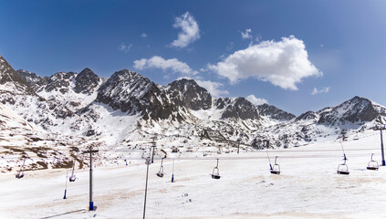 Deserted ski slopes in the middle of the coronavirus pandemic, view of the cable cars in the middle of the mountains	