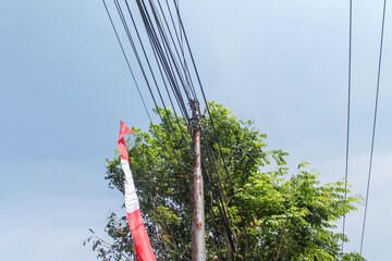 rusty iron pillar covered with electric wires