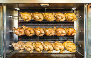 Oven full of roast chickens cooking in their juices