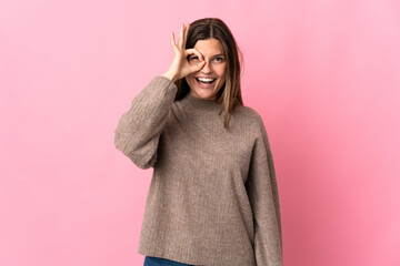 Young slovak woman isolated on pink background showing ok sign with fingers