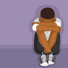 Black depressed boy sitting on floor alone bullying or depression concept 