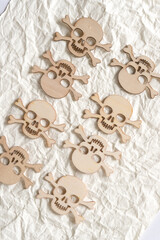 halloween themed wooden shapes arranged on crumpled ivory paper background