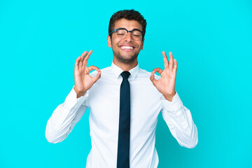 Young business Brazilian man isolated on blue background in zen pose