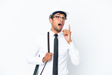 Architect brazilian man with helmet and holding blueprints thinking an idea pointing the finger up