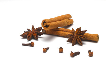Cinnamon, cloves and star anise. Different spices set on white background. Selective focus. 