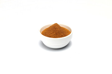ground cinnamon in a  bowl isolated on white background, close up