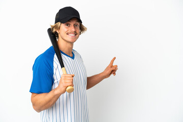 Young blonde man playing baseball isolated on white background pointing back