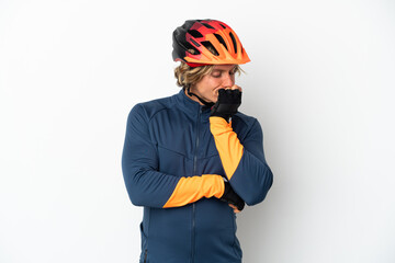 Young blonde cyclist man isolated on white background having doubts