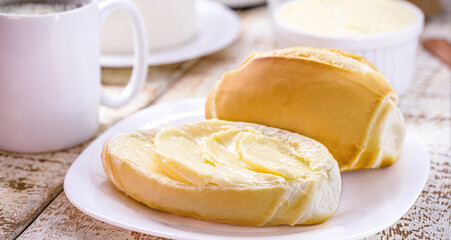 slice of salt bread cut with butter, called French bread in Brazil, Brazilian breakfast