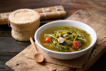 Northern Thai food (Kaeng Puk Plung), Ceylon spinach or Malabar spinach soup with pork in a bowl on wooden, Local Thai food