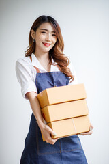 Portrait of Starting small businesses SME owners female entrepreneurs working, box and check online orders to prepare to pack the boxes, sell to customers, sme business ideas online.