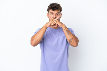 Fototapeta premium Young caucasian handsome man isolated on white background showing a sign of silence gesture