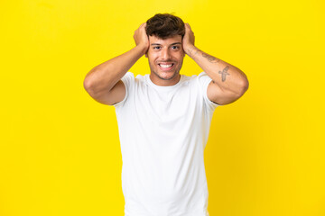 Young caucasian handsome man isolated on yellow background doing nervous gesture