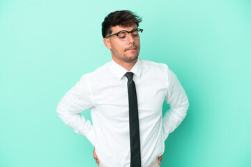 Business caucasian man isolated on blue background suffering from backache for having made an effort