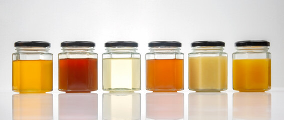 Hexagonal jars with different types and colors of fresh flower honey. vitamin food for health and life