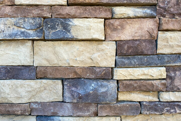 close up view of new stone block structure building wall dark and light color cut stones