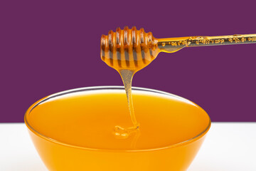 fresh honey drips from a spoon into a plate. organic vitamin health food