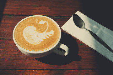 hot latte art coffee on wood table, relax time
