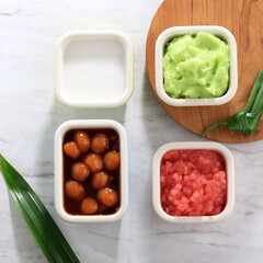 Ingredient of Es Bubur Sumsum or Es Bubur Lemu Bandung, Popular Traditional Porridge from West Java, Made from Rice Flour, Candil (Sticky Rice Ball), and Tapioca Pearl. Top View