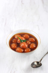 Biji Salak  (or Candil) is Indonesian Famous Dessert during Ramadan Breakfasting. Made from Sweet Potato or Yellow Pumpkin Kabocha Balls with Palm Sugar Syrup and Coconut Milk. Copy Space for text